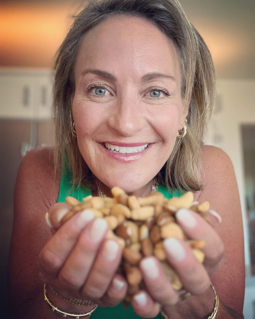 A woman holding some nuts in her hands